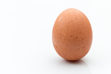 Single Brown egg isolated on a white background.