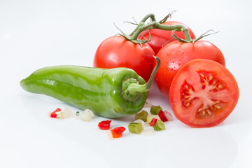 Tomatoes with a green pepper and diced peppers and onions.