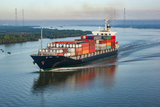 Container ship with many colourful containers in harbour
