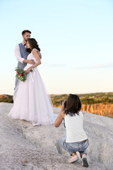 Wedding photographer taking photo of bride and groom