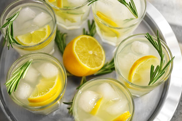 Cold fresh cocktails with lemon on metal tray