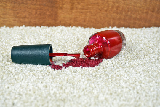 red nail polish spilled on light colored carpet