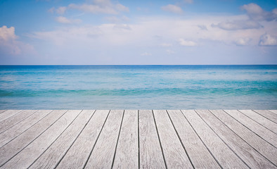 Wooden floor with beautiful ocean and blue sky