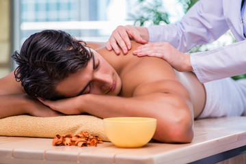 Obraz na płótnie Canvas Man during massage session in spa salon