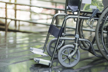 Fototapeta na wymiar Empty wheelchair parked in hospital
