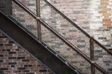 Peel and stick wall murals Stairs iron stairs set with patterned steps on the old brick background