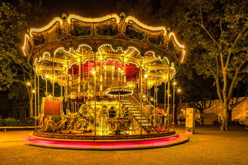 Brightly illuminated traditional carousel in Paris France at night...