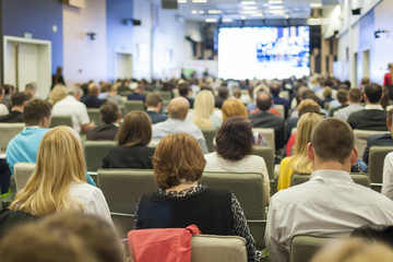 Large Group of People on a Conference. Watching Business Presentation on Board in Front