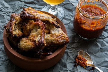 Chicken Wings in a bowl  with sauce and beverage