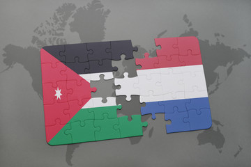 puzzle with the national flag of jordan and netherlands on a world map background.