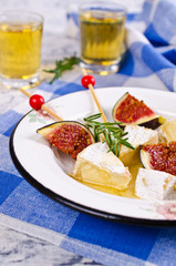 Pieces of Camembert and figs