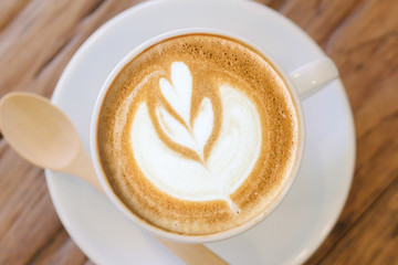 Cup of coffee latte art on wood table