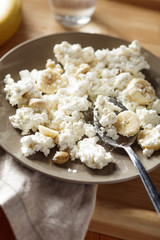 Plate of cottage cheese with banana and nuts