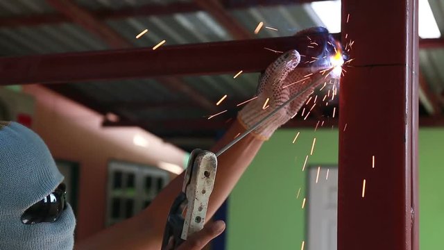 Welder at work in metal industry and build structure