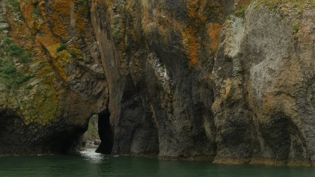 huge granite rock in avacha bay kamchatka peninsula as seen from sea