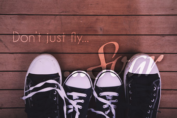 Old canvas shoes on a wooden floor Vintage Retro Filter.