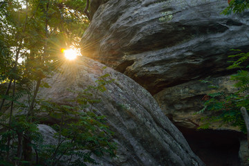 Sun looks out between big rocks