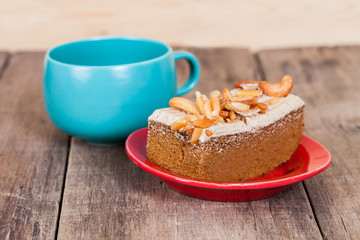 Coffee cake with cashew nut on wood table
