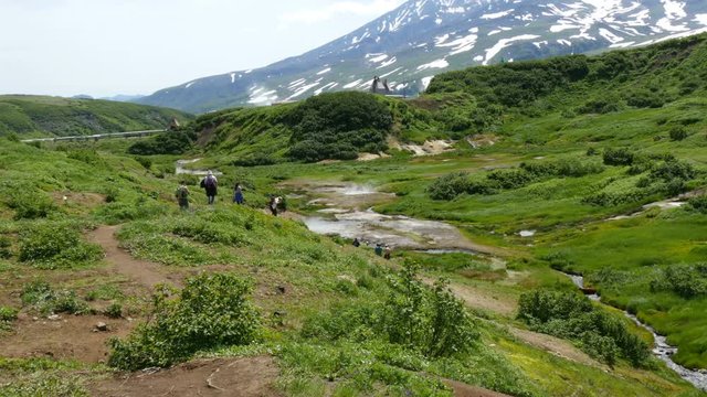 tourists trekking in valley at mutnovksky volcano kamchatka