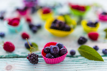 Tasty ripe and fresh forest fruits on stone background. 