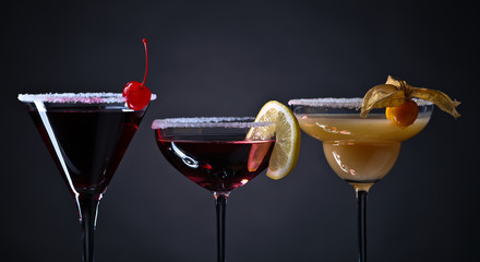  cocktails with fruits on a dark background