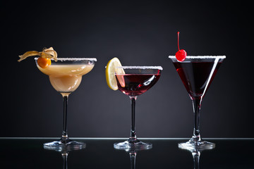  cocktails with fruits on a dark background