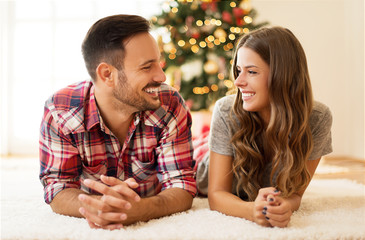 Young, loving couple enjoying on a Christmas morning