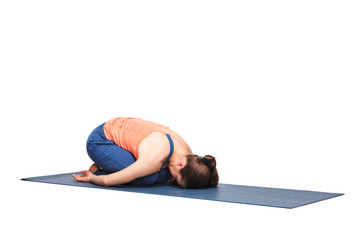 Beautiful sporty fit yogi girl practices yoga asana balasana
