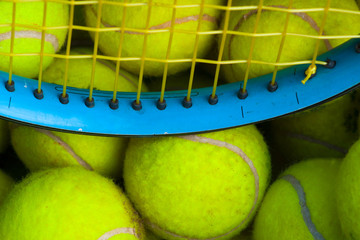 Tennis balls and a racket