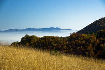 Obraz premium Autumn fog is rolling between hills of Zeljin mountain, Serbia