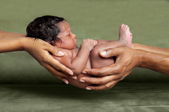 African American Parent Hands Holding Their Newborn