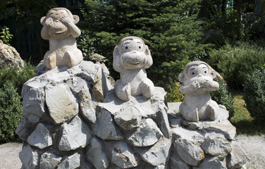 Fototapeta na wymiar Sculpture of three monkeys in the park taigan
