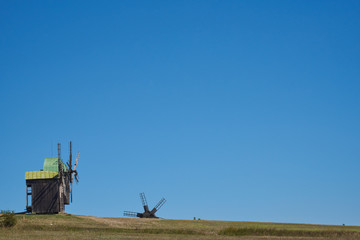 Landscape with windmills on the background of blue sky. Backgrou