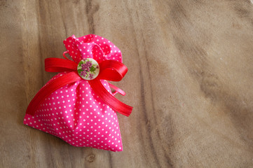 Pink gift bag on wood