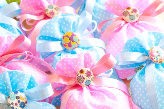 Many pink and blue gift bags
