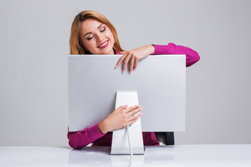 young woman sitting in the table and using computer