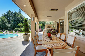 Relaxing outdoor seating arrangement overlooking swimming pool.