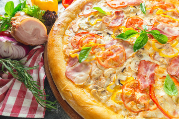 Pizza with dry cured ham and basil