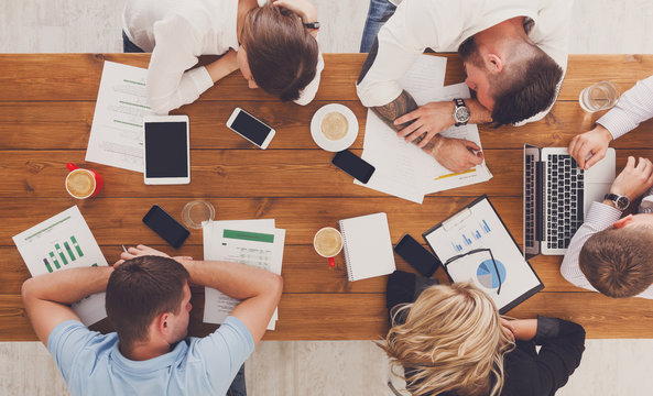 Group of business people exhausted sleep in office, top view