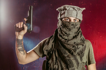 Portrait of man with handgun against colored background