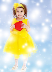 Cute little girl holds heart