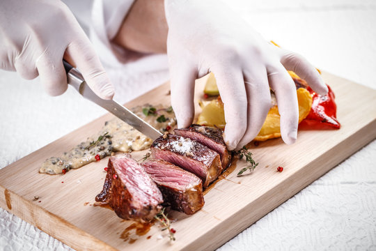 Chef cutting beef steak