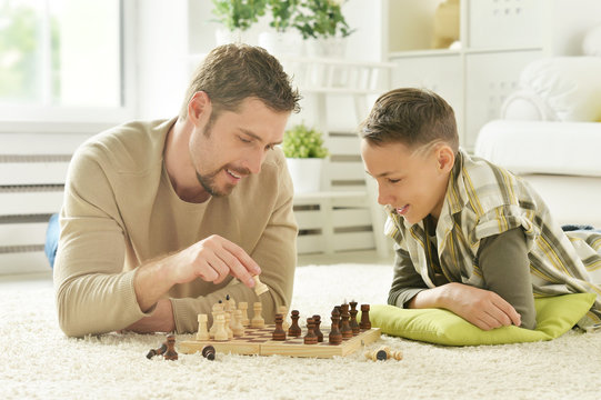 Father And Son Playing Chess