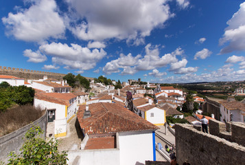 Fototapeta na wymiar Over the roofs of the old town of Obidos, a medieval town in Portugal
