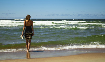 Alone girl in front of the sea