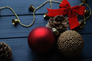 Red and golden Christmas decorations on wooden background