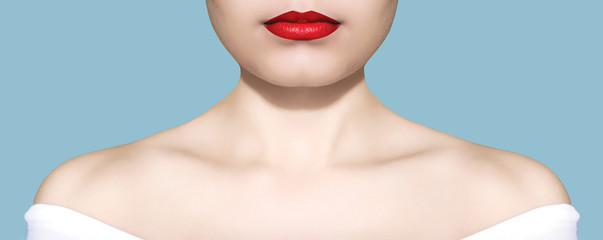 Beauty woman portrait white skin and red lips closeup over blue