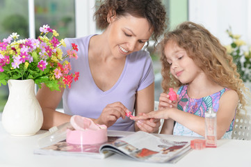 mother with little daughter  with magazine 