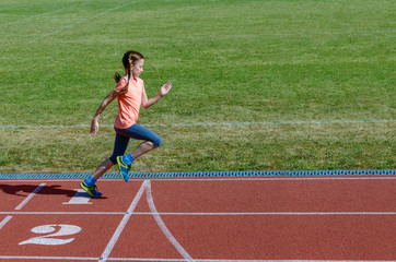 Kids sport, child running on stadium track, training and fitness concept
