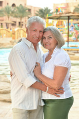 Naklejka premium Senior couple near pool